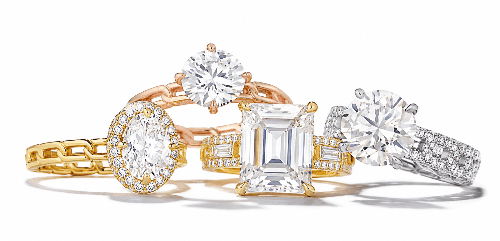 Selection of diamond engagement rings in yellow gold, rose gold and platinum