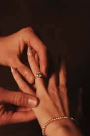 Placing a diamond ring on a finger